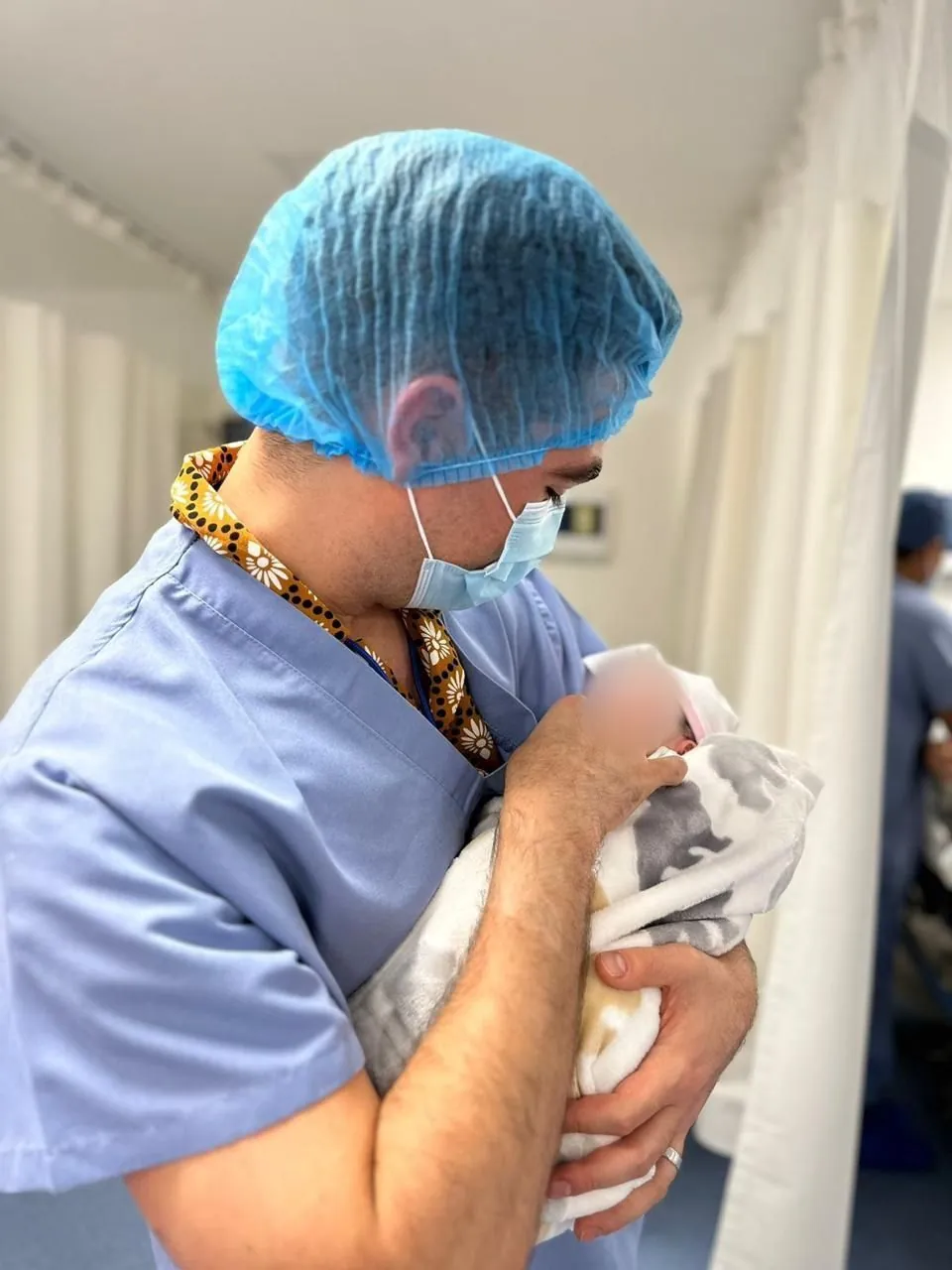 A father holding his newborn for the first time in a private hospital in Cancún