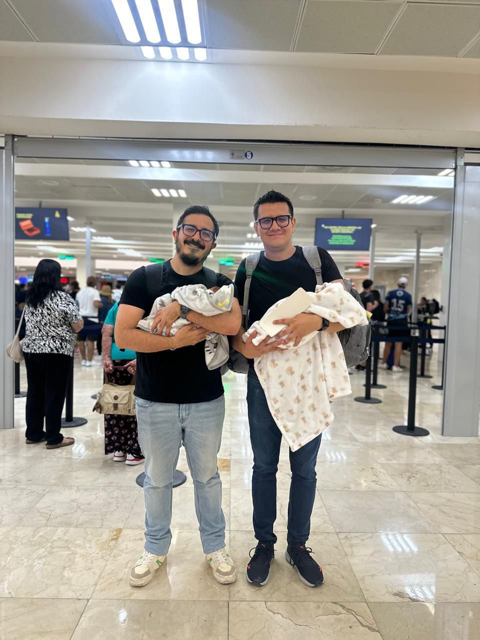 Family with twins at the airport — heading home